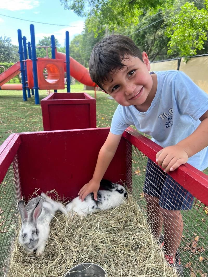 A student petting bunnies