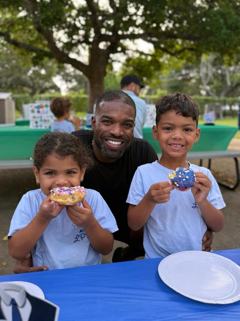 A dad and his two children at a family event