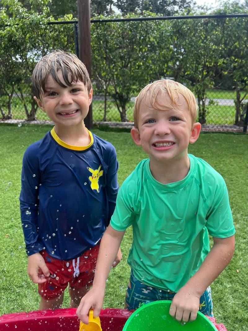 Two students smiling at water play