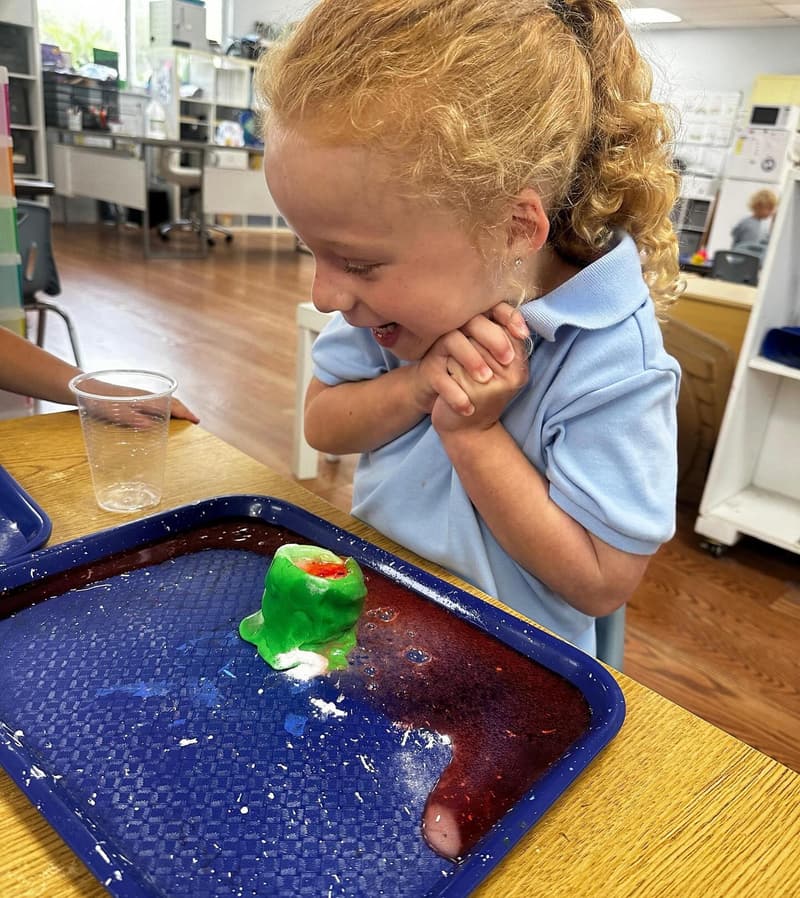A student exploring a water play tray