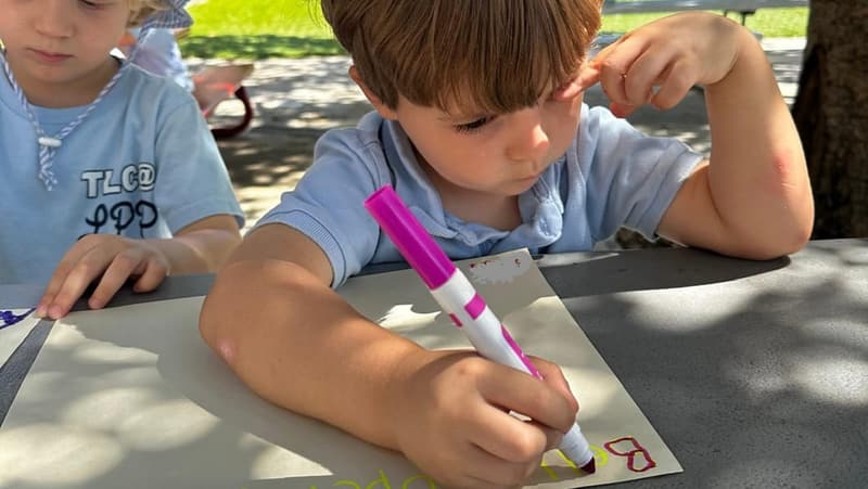 A student practicing writing letters